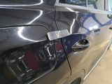 a close up of a car door handle with a sticker on it