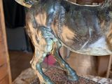 statue of a horse on a pedestal in a room