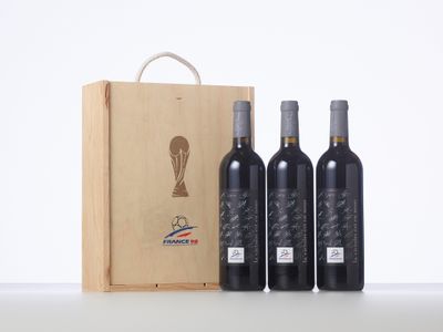 three bottles of wine in front of a wooden box