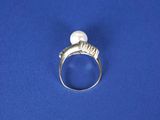 silver ring with a white pearl and a silver band on a blue background