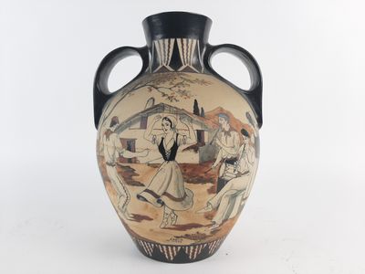 a vase with a painting on it sitting on a table