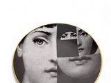 black and white photograph of a plate with a woman ' s face on it