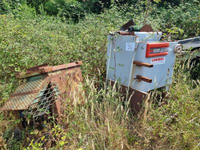 un camion garé dans l'herbe à côté d'un autre camion