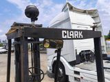 a fork lift truck parked in front of a white truck
