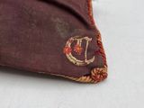 a brown bag with a red and gold design on it