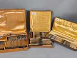 four different types of silverware in a case on a table