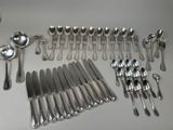 a lot of silver spoons and forks on the table