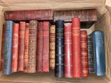 a box full of old books sitting on a shelf