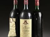 three bottles of wine are lined up in a row on a table