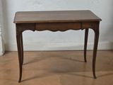 a small wooden table with a drawer underneath it