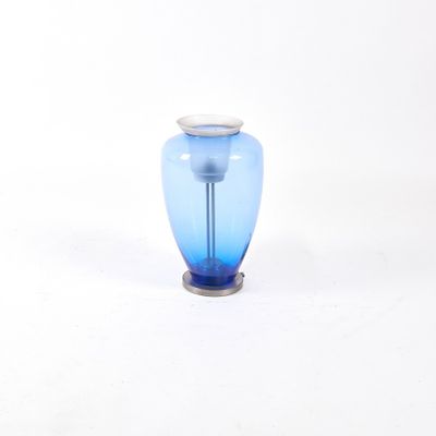 a blue glass vase with a silver base on a white background