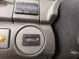 a close up of a car dashboard with a button on it