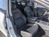 the interior of a white car with black leather seats and a center console
