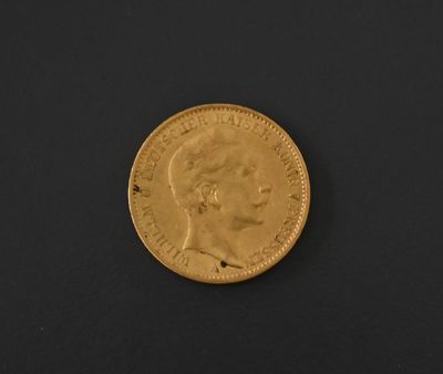 a close up of a gold coin on a black surface
