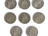 six different types of coins are shown on a white surface