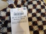 a label on the tag of a sweater on a table