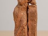 a statue of a man and a woman sitting on a table