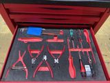 a red tool box with tools in it on the floor