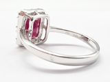 an oval ruby and diamond ring on a white background