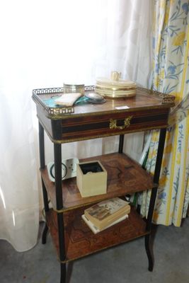 a small table with books on it in front of a window