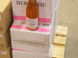 several boxes of wine are stacked on a pallet in a warehouse