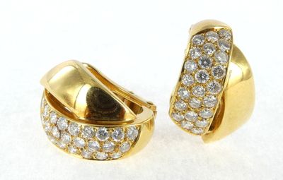 pair of yellow gold and diamond earrings on a white surface