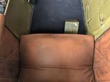 a brown leather chair with a black seat and a brown seat cushion