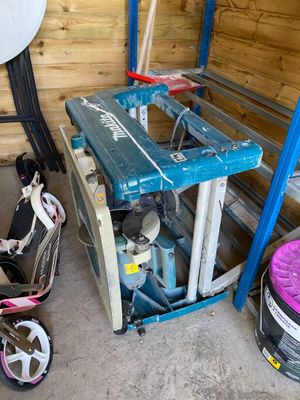 a small child ' s bike in a garage next to a blue and white machine
