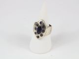 a close up of a silver ring with blue stones on it