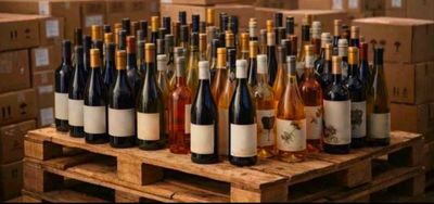 many bottles of wine sitting on a wooden pallet