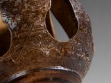 a close up of a vase with a hole in it