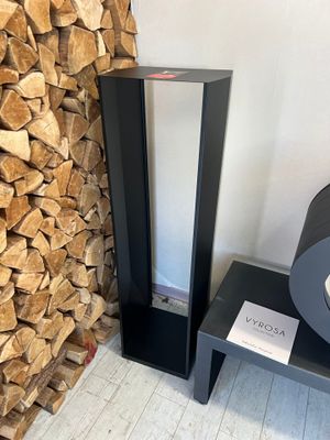 a stack of firewood next to a black table