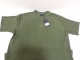 green shirt with a tag on the neck and a tag on the chest