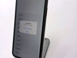 an iphone with a broken screen sitting on top of a table