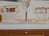 a painting of a man holding a tennis racquet on a wall