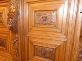 a wooden cabinet with carvings on it in a room