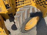 a large tire on the back of a construction vehicle