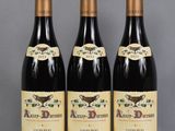 three bottles of wine sitting on top of a table next to each other
