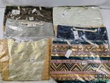 four bags of different colors and designs on the table