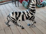 a statue of a zebra and a horse on a porch