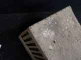 a box that is sitting on the ground next to a piece of paper