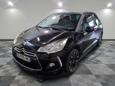 la petite voiture noire est garée sur un sol en damier