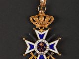 a close up of a medal with a crown on it