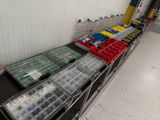 a long table that has many containers of legos on it