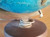 a close up of a blue globe on a wooden table