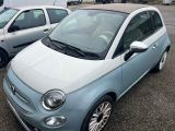 two small cars parked next to each other in a parking lot