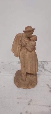 a statue of a woman holding a child on a table