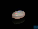 a white oplite in the dark with a black background