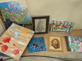 many paintings on a table with pictures on it