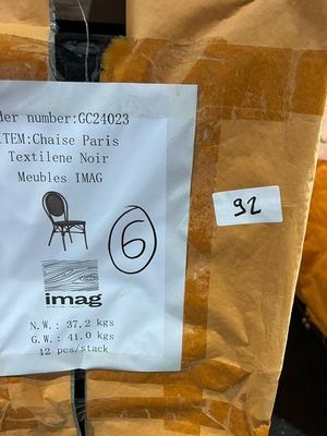 a sign on the back of a chair in a store